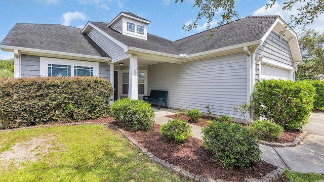 1001 Bonita Loop, Myrtle Beach, SC 29588 - view of front facade with an attached garage, a shingled roof, and a front lawn