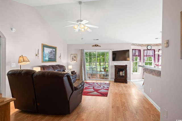 6506 Royal Pine Dr, Myrtle Beach, SC 29588 - living room featuring ceiling fan, light wood-style flooring, arched walkways, and high vaulted ceiling