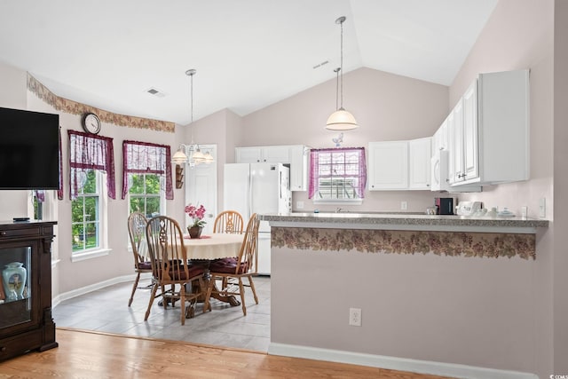 6506 Royal Pine Dr, Myrtle Beach, SC 29588 - dining area featuring vaulted ceiling, a chandelier, and light wood-style flooring