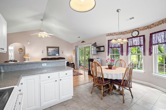 6506 Royal Pine Dr, Myrtle Beach, SC 29588 - dining space featuring a chandelier, a ceiling fan, vaulted ceiling, arched walkways, and light tile patterned flooring
