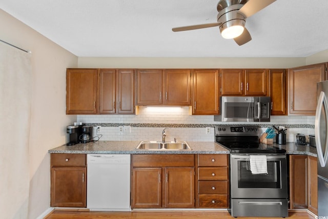 1011 Hunter Ave Unit 1, North Myrtle Beach, SC 29582 - kitchen featuring stainless steel appliances, brown cabinetry, and decorative backsplash