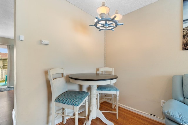 1011 Hunter Ave Unit 1, North Myrtle Beach, SC 29582 - dining area featuring a chandelier, wood finished floors, and a textured ceiling