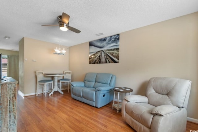 1011 Hunter Ave Unit 1, North Myrtle Beach, SC 29582 - sitting room featuring a ceiling fan, a textured ceiling, wood finished floors, and a chandelier