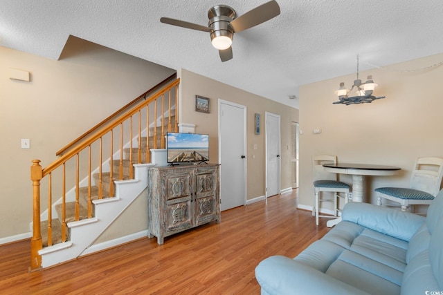 1011 Hunter Ave Unit 1, North Myrtle Beach, SC 29582 - living area featuring wood finished floors, a chandelier, ceiling fan, stairs, and a textured ceiling