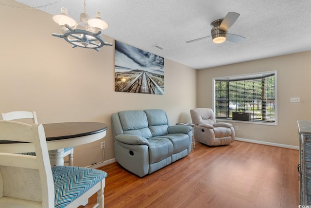1011 Hunter Ave Unit 1, North Myrtle Beach, SC 29582 - living room featuring a chandelier, wood finished floors, a textured ceiling, and a ceiling fan