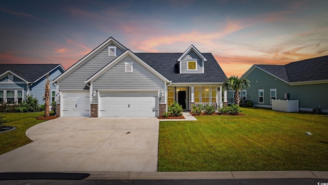 5540 Whitebark Dr, Myrtle Beach, SC 29577 - traditional home with a lawn, driveway, covered porch, and a garage
