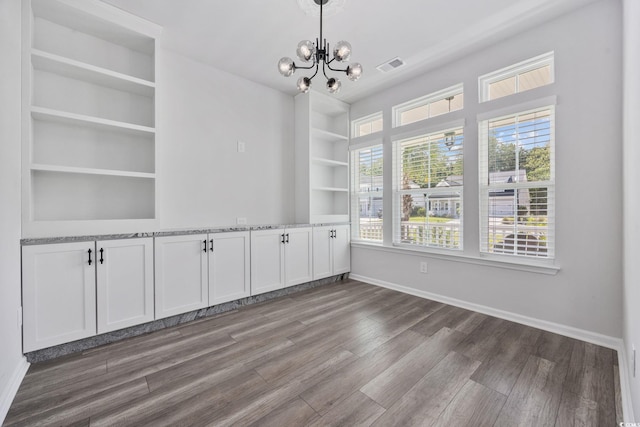 5540 Whitebark Dr, Myrtle Beach, SC 29577 - unfurnished dining area featuring a chandelier, wood finished floors, and built in shelves