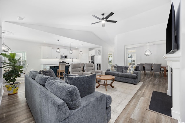 5540 Whitebark Dr, Myrtle Beach, SC 29577 - living room with wood finished floors, ceiling fan, vaulted ceiling, a chandelier, and recessed lighting