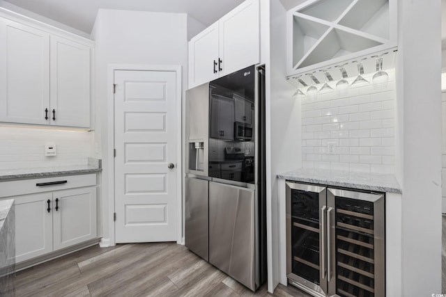 5540 Whitebark Dr, Myrtle Beach, SC 29577 - kitchen with refrigerator with ice dispenser, wine cooler, decorative backsplash, and white cabinets