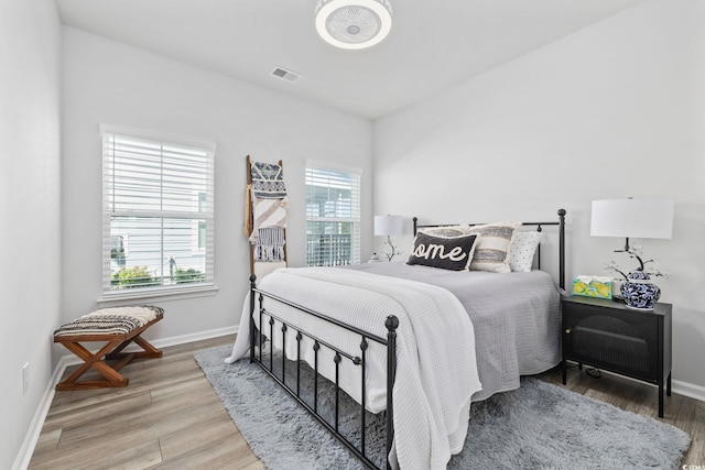 5540 Whitebark Dr, Myrtle Beach, SC 29577 - bedroom with multiple windows and light wood-type flooring