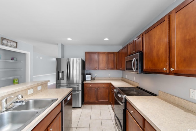 632 Kindred Dr, Myrtle Beach, SC 29588 - kitchen featuring appliances with stainless steel finishes, light tile patterned flooring, light countertops, brown cabinetry, and recessed lighting