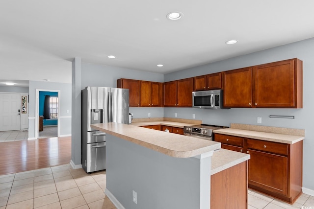632 Kindred Dr, Myrtle Beach, SC 29588 - kitchen with stainless steel appliances, light countertops, a kitchen island, light tile patterned floors, and recessed lighting