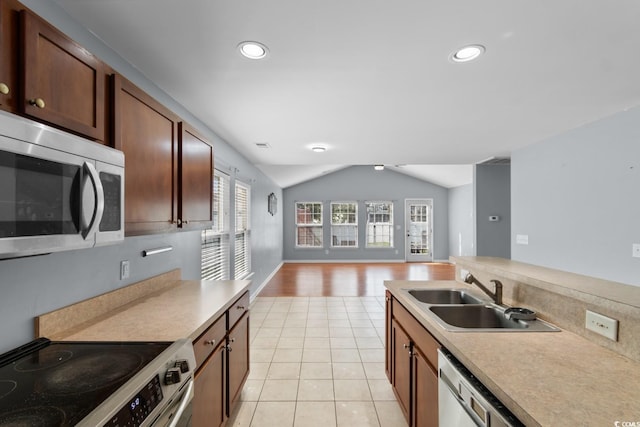 632 Kindred Dr, Myrtle Beach, SC 29588 - kitchen with stainless steel appliances, lofted ceiling, light countertops, open floor plan, and recessed lighting