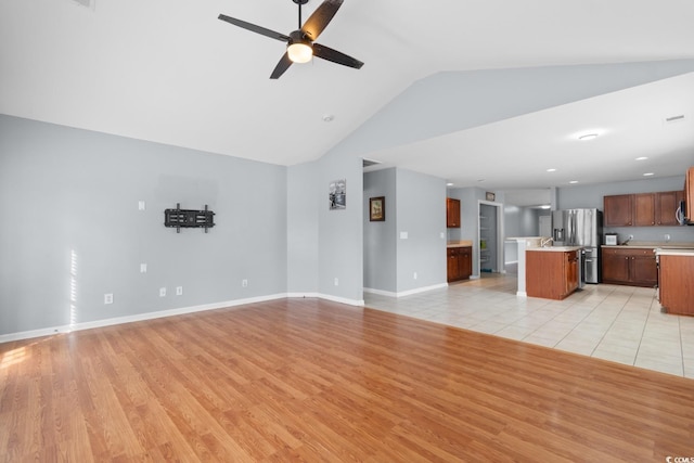 632 Kindred Dr, Myrtle Beach, SC 29588 - unfurnished living room featuring lofted ceiling, a ceiling fan, light wood finished floors, and recessed lighting
