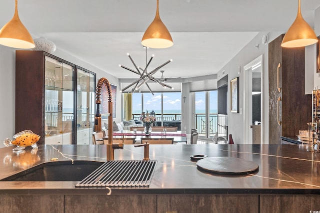 603 S Ocean Blvd Unit 1109, North Myrtle Beach, SC 29582 - kitchen featuring stainless steel countertops, open floor plan, a chandelier, and hanging light fixtures