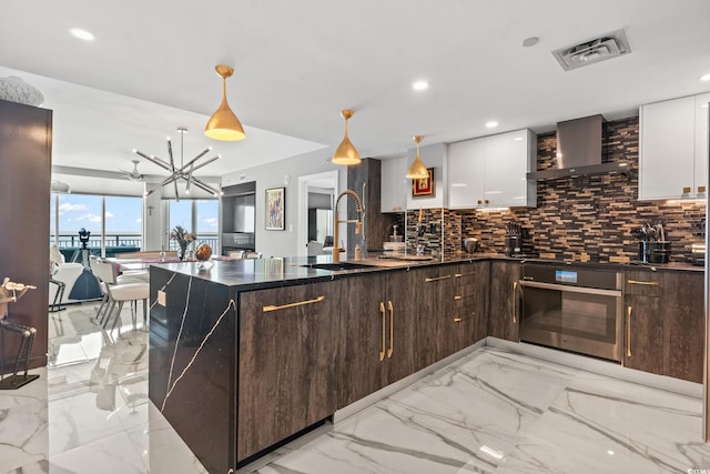603 S Ocean Blvd Unit 1109, North Myrtle Beach, SC 29582 - kitchen featuring backsplash, oven, dark brown cabinetry, white cabinetry, and recessed lighting