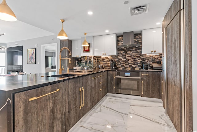 603 S Ocean Blvd Unit 1109, North Myrtle Beach, SC 29582 - kitchen featuring modern cabinets, light marble finish floors, oven, decorative backsplash, and white cabinetry