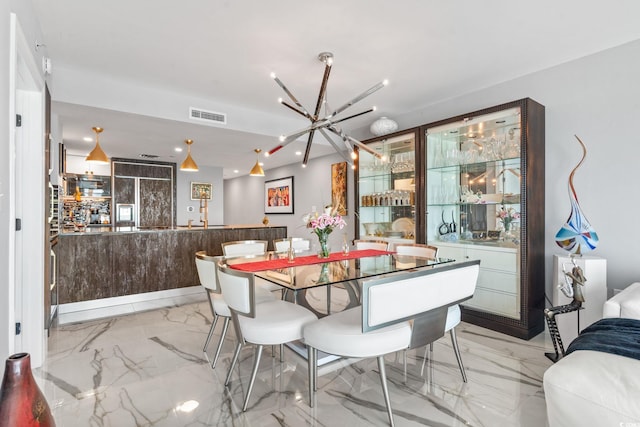 603 S Ocean Blvd Unit 1109, North Myrtle Beach, SC 29582 - dining area featuring a chandelier and light marble finish flooring