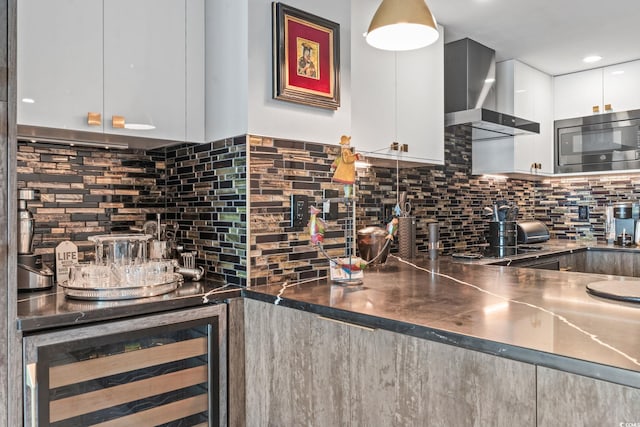 603 S Ocean Blvd Unit 1109, North Myrtle Beach, SC 29582 - kitchen with modern cabinets, beverage cooler, wall chimney exhaust hood, stainless steel microwave, and decorative backsplash