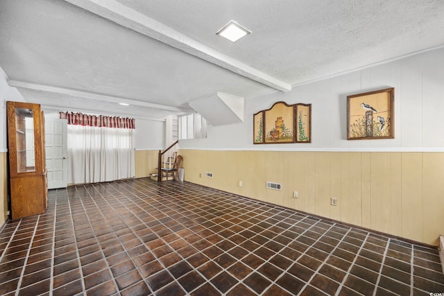 708 Charlotte Rd, Myrtle Beach, SC 29577 - spare room with a textured ceiling, stairway, and beamed ceiling