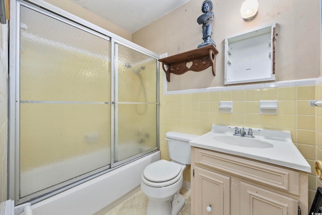 708 Charlotte Rd, Myrtle Beach, SC 29577 - full bath featuring shower / bath combination with glass door, vanity, tile walls, and wainscoting
