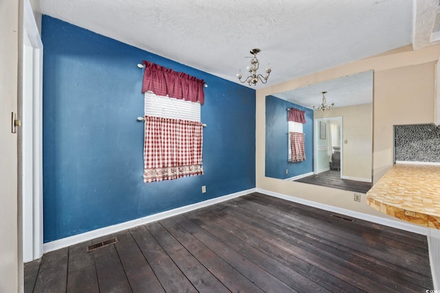708 Charlotte Rd, Myrtle Beach, SC 29577 - unfurnished dining area featuring a chandelier, hardwood / wood-style flooring, and a textured ceiling