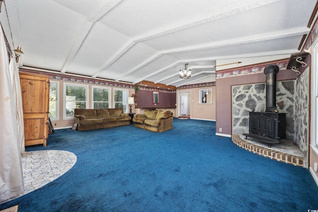 708 Charlotte Rd, Myrtle Beach, SC 29577 - unfurnished living room with vaulted ceiling, a wood stove, carpet, and a chandelier
