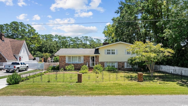 708 Charlotte Rd, Myrtle Beach, SC 29577 - view of front of house featuring brick siding, a fenced front yard, and driveway