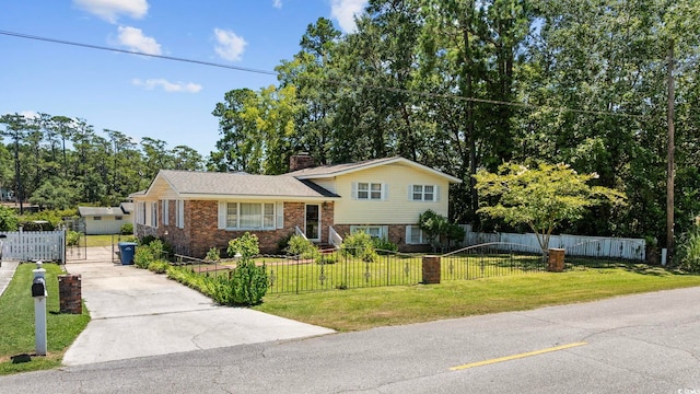 708 Charlotte Rd, Myrtle Beach, SC 29577 - split level home featuring driveway, brick siding, a chimney, a fenced front yard, and a gate