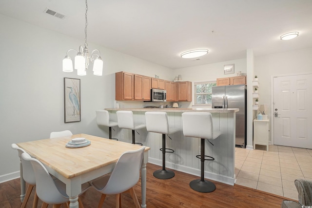 6253 Catalina Dr Unit 1113, North Myrtle Beach, SC 29582 - dining room with a chandelier and light wood-style floors