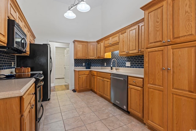 188 Governors Loop, Myrtle Beach, SC 29588 - kitchen with appliances with stainless steel finishes, decorative backsplash, light tile patterned flooring, light countertops, and brown cabinets