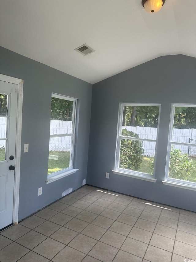 704 Coffee Tree Ct, Myrtle Beach, SC 29579 - spare room featuring plenty of natural light, lofted ceiling, and light tile patterned flooring