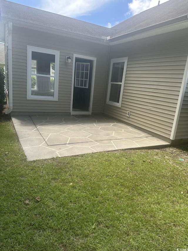 704 Coffee Tree Ct, Myrtle Beach, SC 29579 - rear view of property with a patio, a lawn, and a shingled roof