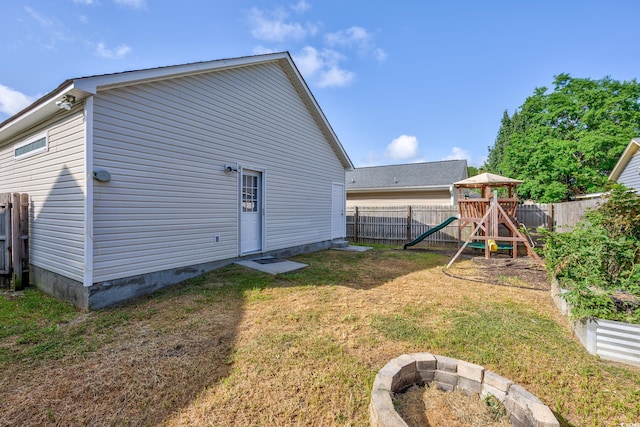 1315 Melanie Ln, Myrtle Beach, SC 29577 - rear view of property featuring a playground and a fenced backyard