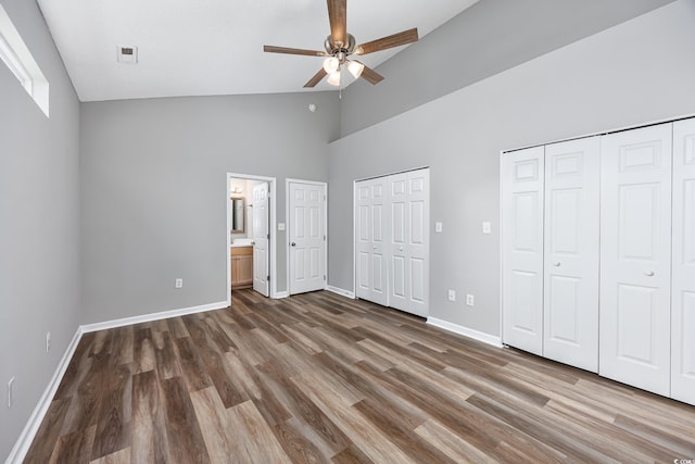1315 Melanie Ln, Myrtle Beach, SC 29577 - unfurnished bedroom featuring two closets, high vaulted ceiling, wood finished floors, ensuite bathroom, and a ceiling fan