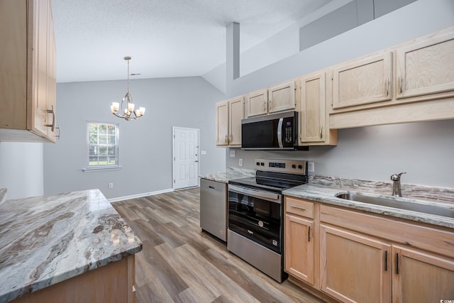 1315 Melanie Ln, Myrtle Beach, SC 29577 - kitchen featuring light brown cabinetry, appliances with stainless steel finishes, lofted ceiling, wood finished floors, and a chandelier