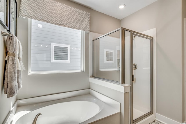 bathroom with separate shower and tub