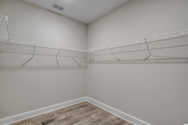 spacious closet with light hardwood / wood-style flooring