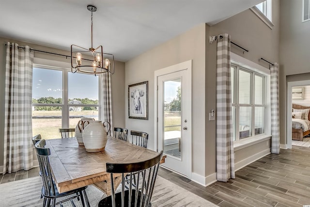 dining area featuring an inviting chandelier and light hardwood / wood-style floors