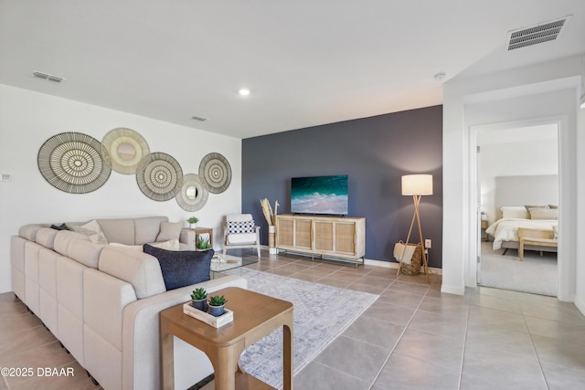 tiled living room featuring recessed lighting, visible vents, and baseboards