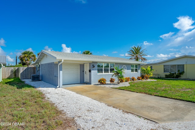 ranch-style house with a garage, central AC, and a front yard