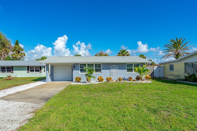 ranch-style house featuring a garage and a front yard