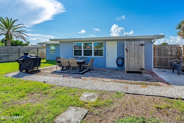 back of house featuring a yard and a patio area