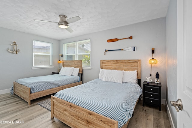 bedroom featuring a textured ceiling, hardwood / wood-style flooring, and ceiling fan