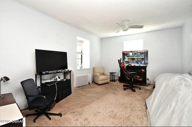 office with visible vents, carpet, and ceiling fan