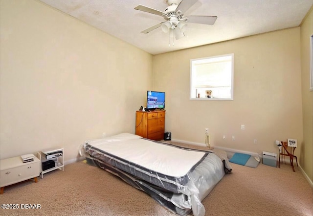 bedroom with baseboards, carpet, and a ceiling fan