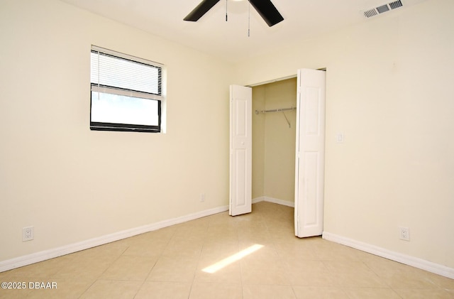 unfurnished bedroom with a closet, visible vents, baseboards, and light tile patterned flooring