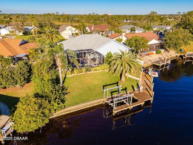 drone / aerial view featuring a water view and a residential view