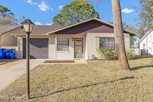 single story home featuring a front lawn, concrete driveway, brick siding, and an attached garage