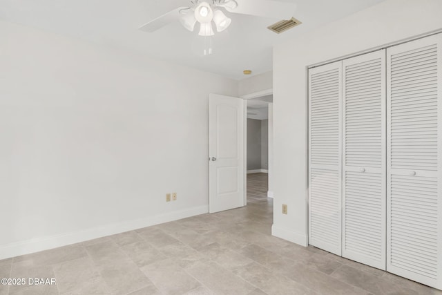 unfurnished bedroom with a ceiling fan, a closet, visible vents, and baseboards